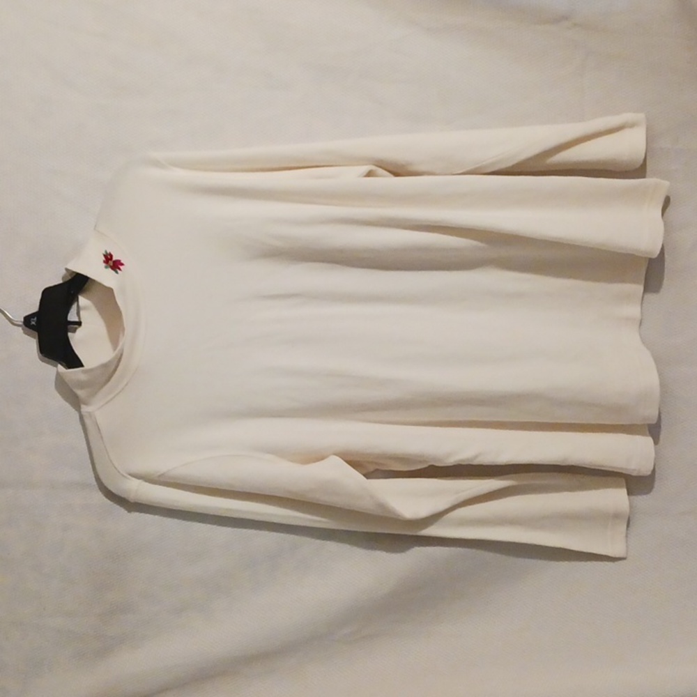 Holiday Edition white turtleneck with poinsettia flower